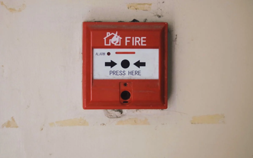 Manual red fire alarm safety system for workers.

