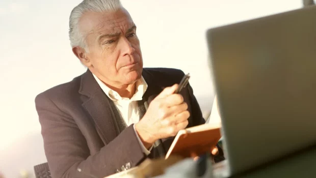 Man in Black Suit Holding A Pen