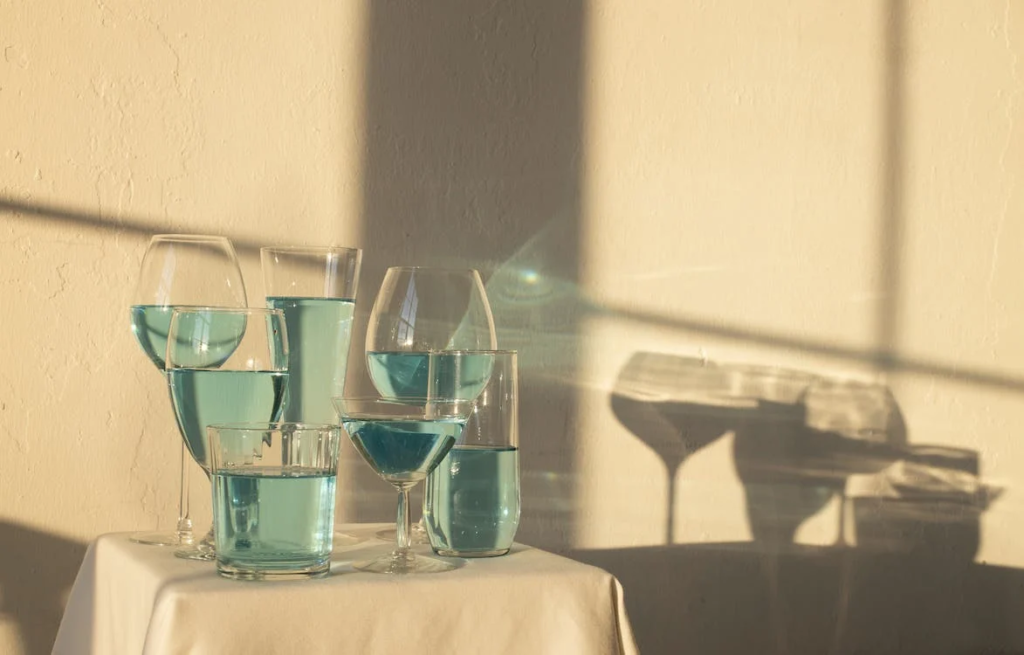 Blue Absinthe drink in glasses on table
