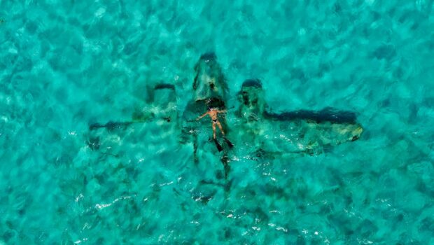 Man Floating above a Plane Wreck