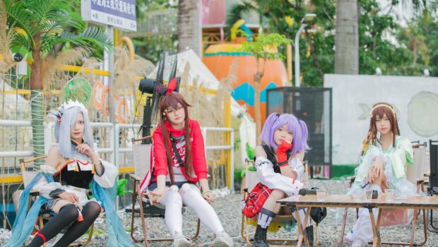 Group of Teenage Girls Posing in Costumes of Manga Video Game Characters