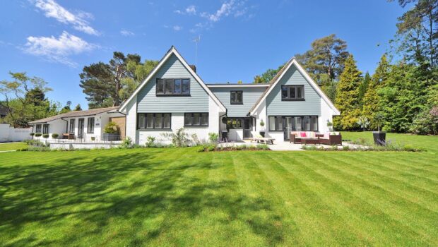 White and Gray Wooden House Near Grass Field and Trees